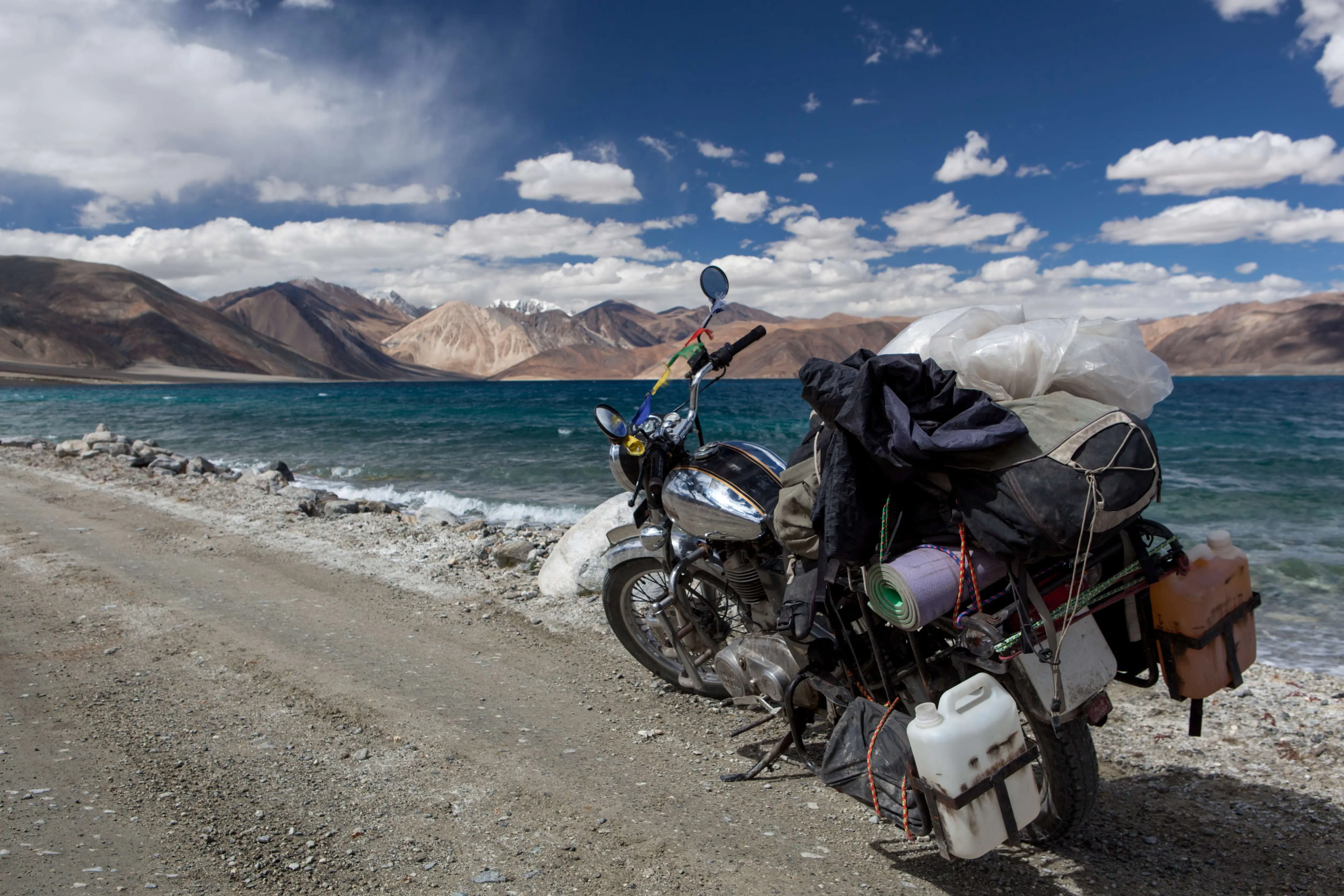 Turquoise water of Pangong Lake below bare brown mountains