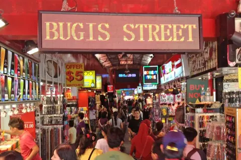 Shoppers under the Bugis Street sign